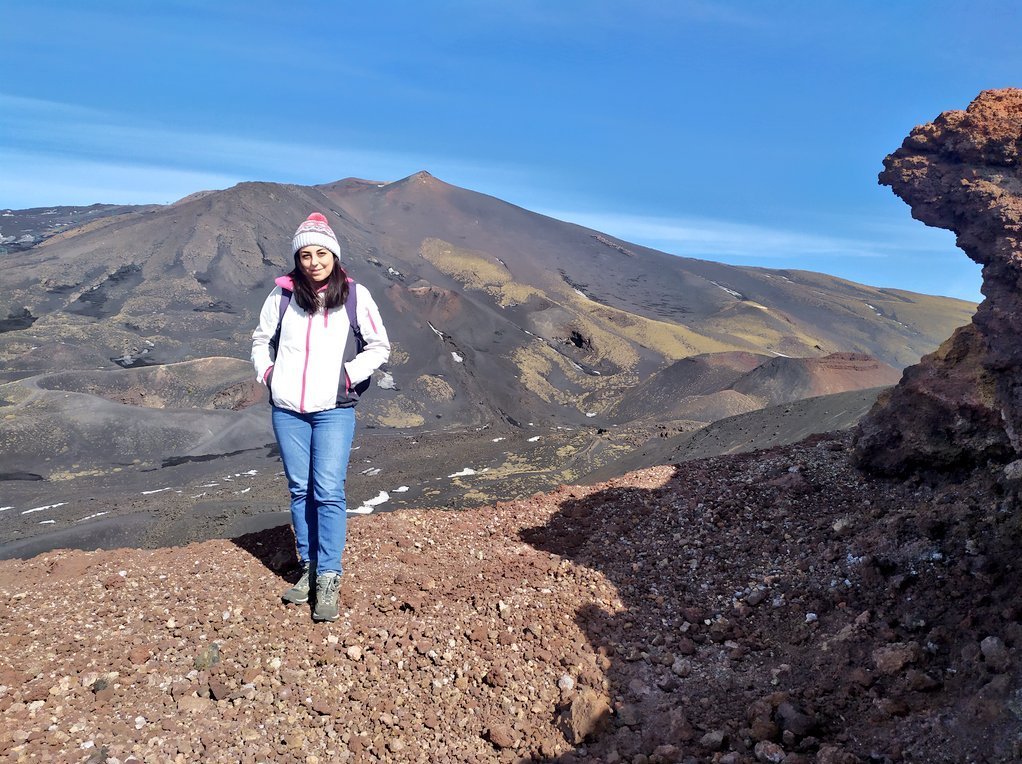 Pınar Büyükakpınar standing on volcanic terrain at Mount Etna in Sicily